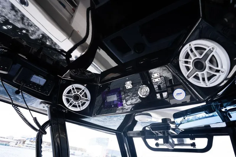 Change Clothes Yacht Photos Pics 2023 Sportsman Open 322 Center Console boat interior with speakers and control panel.