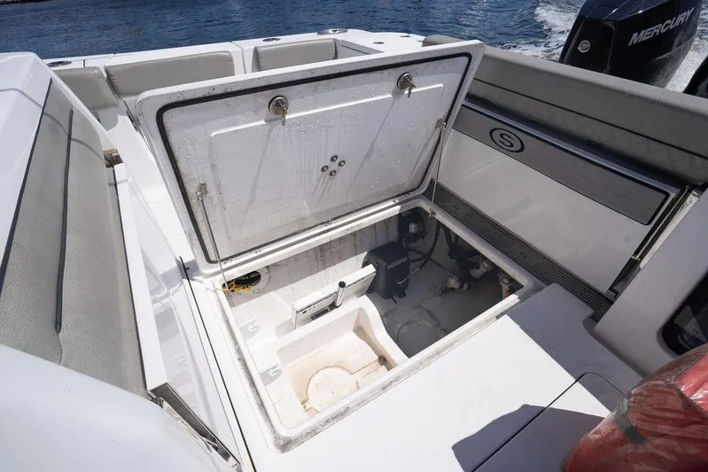 Change Clothes Yacht Photos Pics 2023 Sportsman Open 322 Center Console boat with open storage compartment.