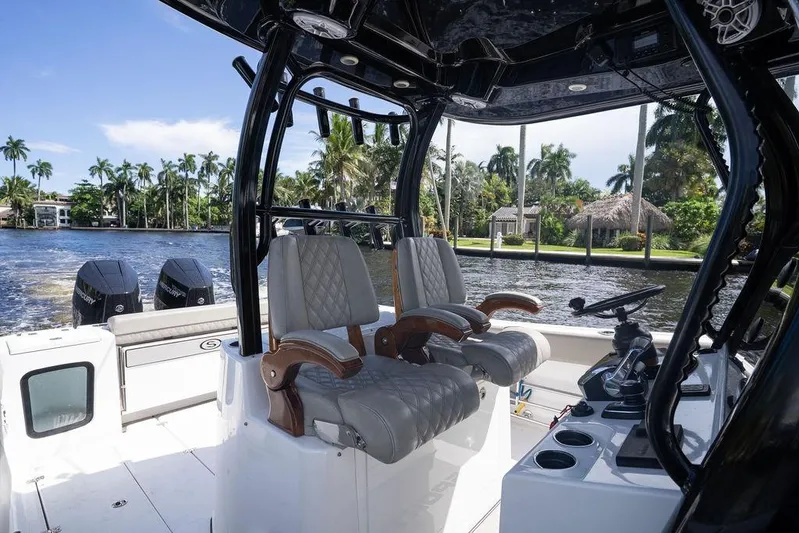 Change Clothes Yacht Photos Pics 2023 Sportsman Open 322 Center Console boat interior with luxurious seating and dual engines.