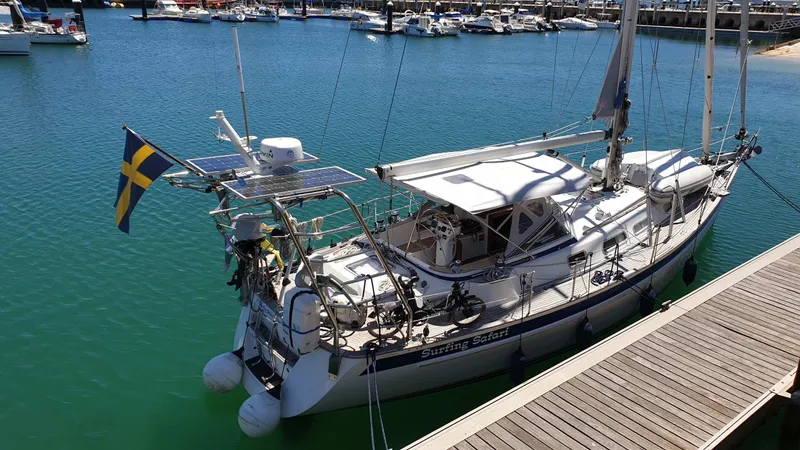 Surfing Safari Yacht Photos Pics Sailing yacht Hallberg-Rassy 40, 2010 model, docked in a marina with Swedish flag.