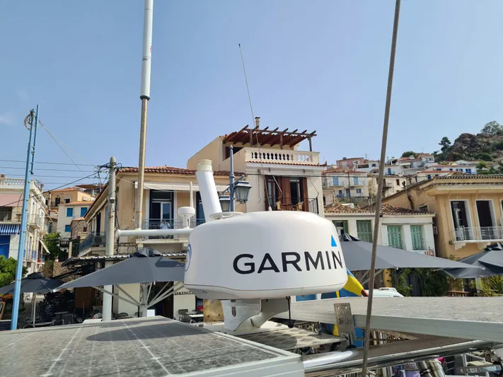 Surfing Safari Yacht Photos Pics Garmin radar on a 2010 Hallberg-Rassy 40 yacht, with coastal buildings in the background.