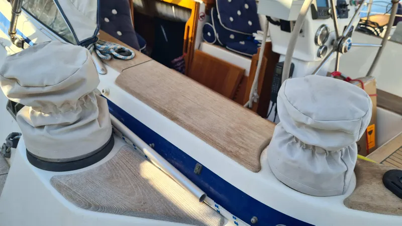 Surfing Safari Yacht Photos Pics Hallberg-Rassy 40 sailboat cockpit with covered winches and wooden seating, 2010 model.