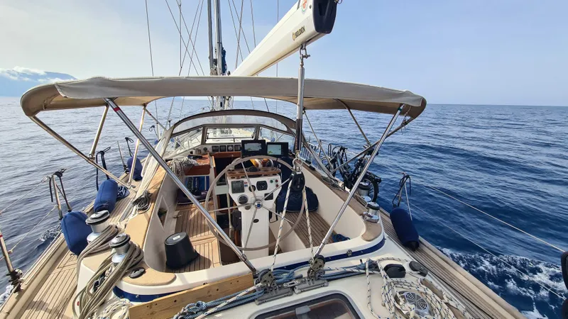 Surfing Safari Yacht Photos Pics Hallberg-Rassy 40 sailboat, 2010 model, cruising on open sea with clear skies.