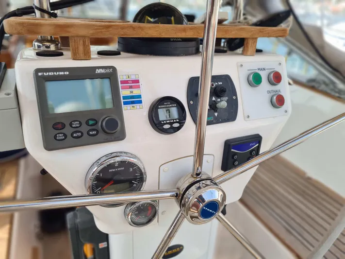 Surfing Safari Yacht Photos Pics Steering wheel and control panel of a 2010 Hallberg-Rassy 40 sailboat.