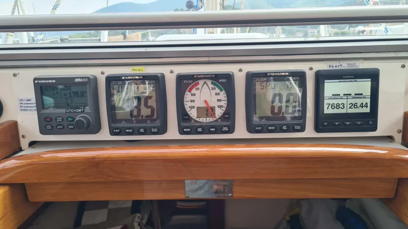 Surfing Safari Yacht Photos Pics Control panel of a 2010 Hallberg-Rassy 40 sailboat with navigation instruments.