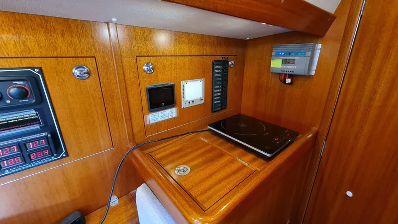 Surfing Safari Yacht Photos Pics Control panel area in a 2010 Hallberg-Rassy 40 yacht with wooden finish.