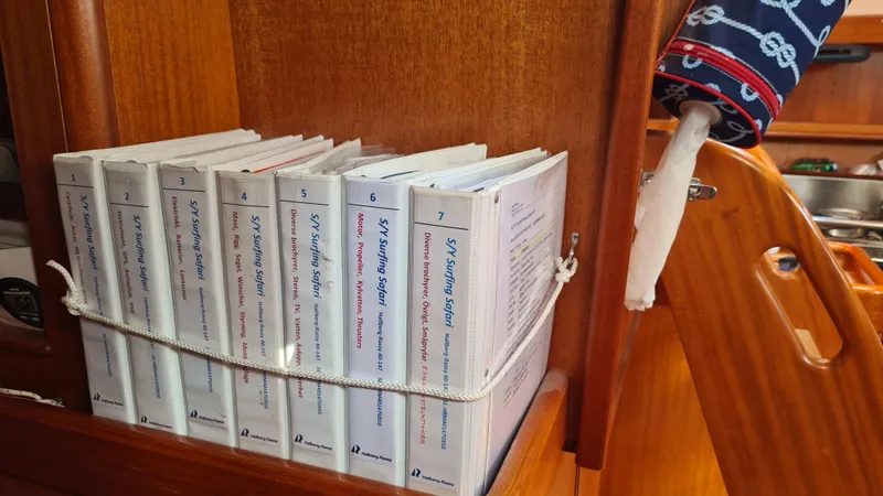 Surfing Safari Yacht Photos Pics Books secured on a Hallberg-Rassy 40 yacht shelf, 2010 model.