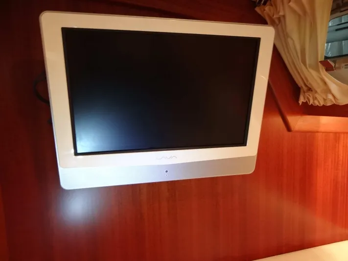 Surfing Safari Yacht Photos Pics Wall-mounted TV inside a 2010 Hallberg-Rassy 40 yacht cabin.