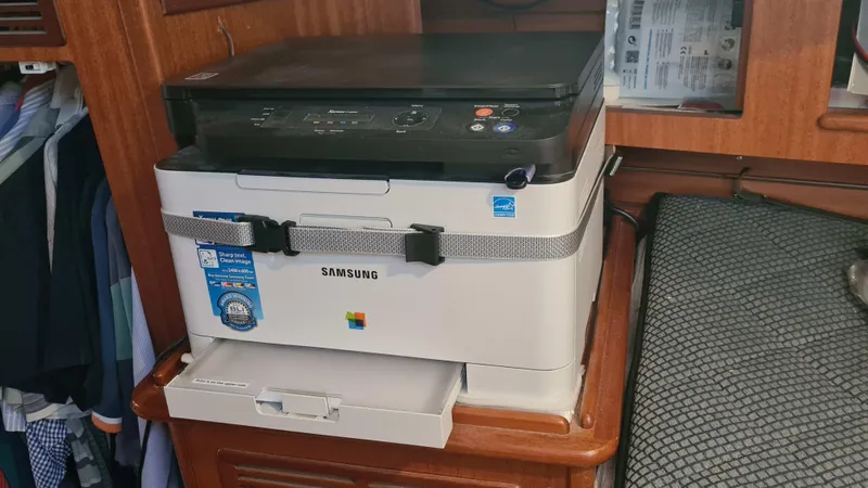 Surfing Safari Yacht Photos Pics Samsung printer secured on a Hallberg-Rassy 40 yacht, 2010 model, with wooden interior.