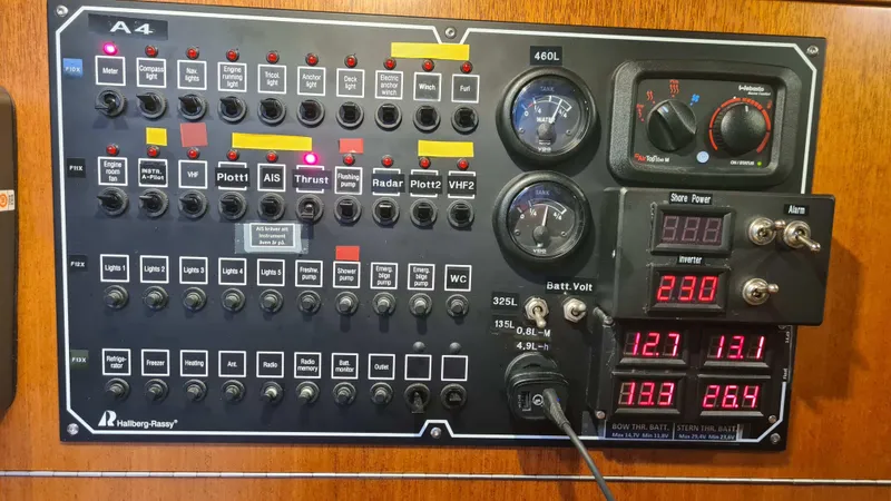 Surfing Safari Yacht Photos Pics Electrical control panel of a 2010 Hallberg-Rassy 40 yacht with gauges and switches.