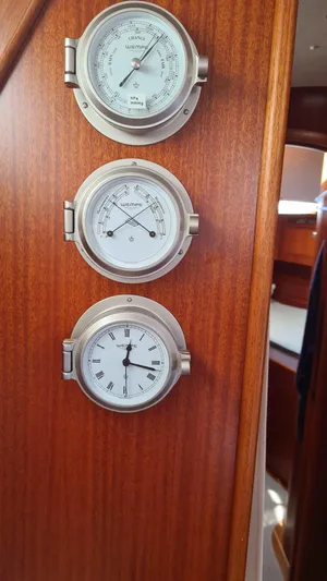 Surfing Safari Yacht Photos Pics Nautical instruments on Hallberg-Rassy 40 yacht, 2010 model, featuring barometer, hygrometer, and clock.