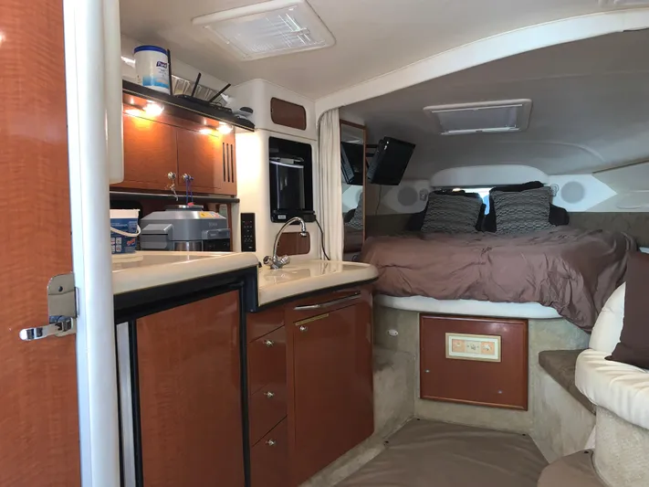 Tbd Yacht Photos Pics 2002 Sea Ray 340 Sundancer cabin interior with kitchenette and cozy sleeping area.