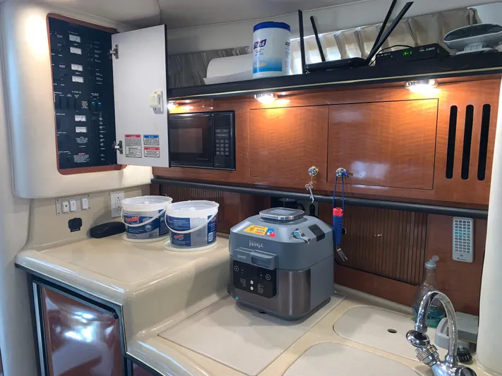Tbd Yacht Photos Pics 2002 Sea Ray 340 Sundancer kitchen with microwave, control panel, and countertop appliances.