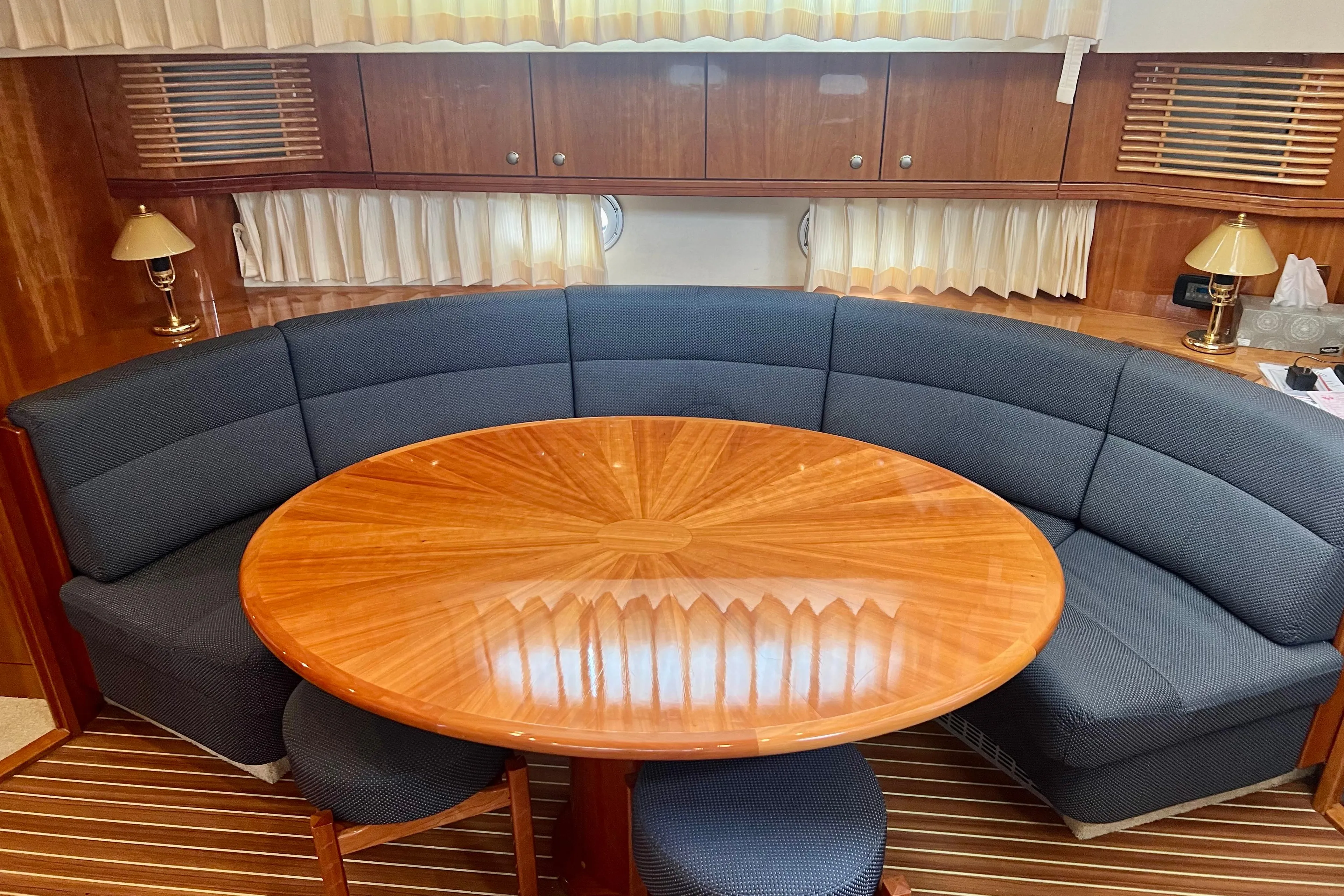 Luxurious Elling E4 2008 yacht interior with elegant wood table and curved seating.