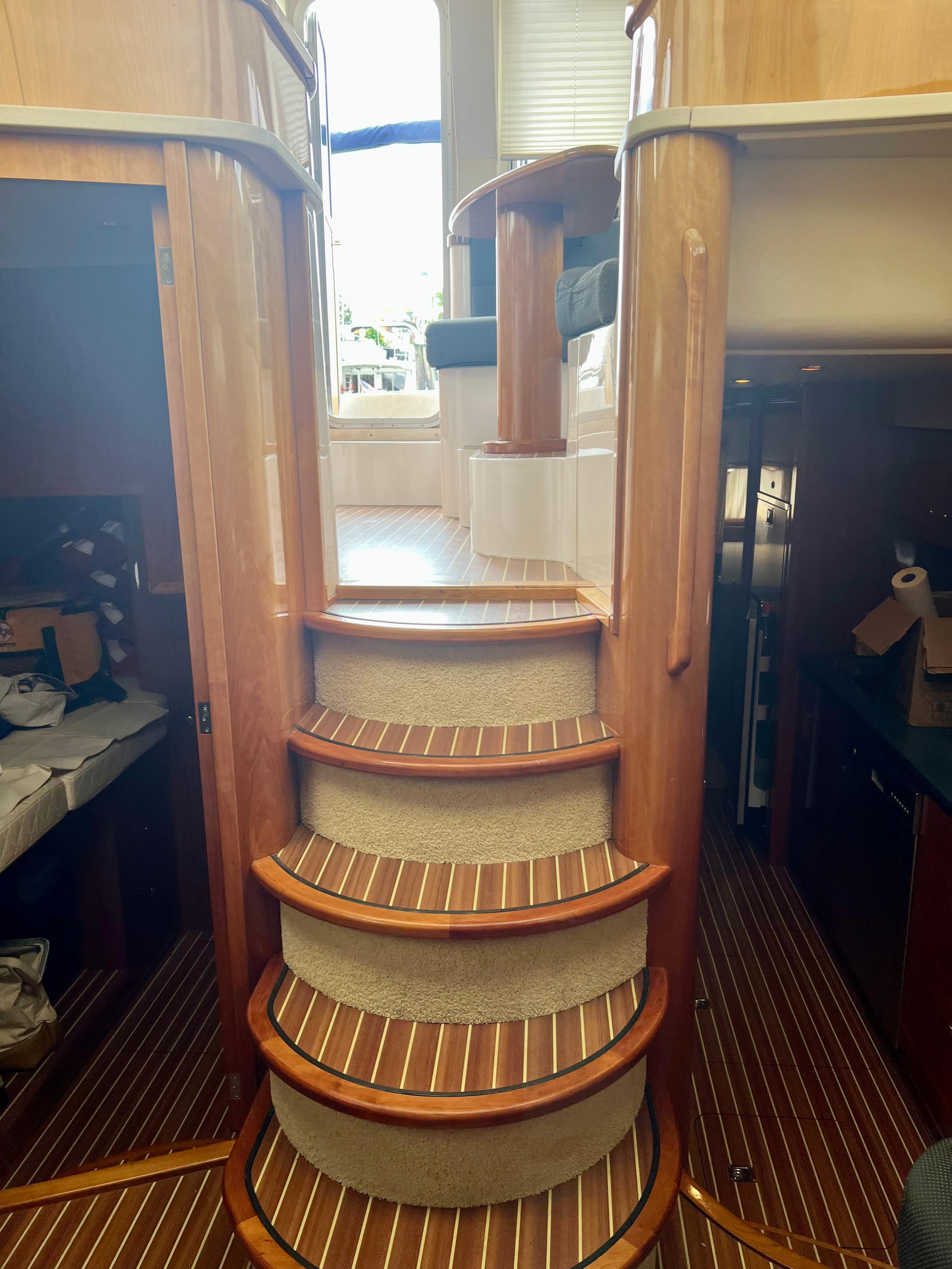 Interior of 2008 Elling E4 yacht with wooden stairs and elegant cabin design.