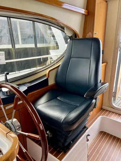 "lexi Lu" Yacht Photos Pics Captain's chair in 2008 Elling E4 yacht cockpit, featuring leather upholstery and wooden accents.