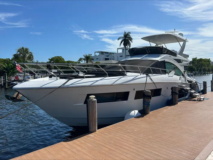 Rio Yacht Photos Pics 2017 Cruisers Yachts 60 Fly docked by a sunny waterfront.