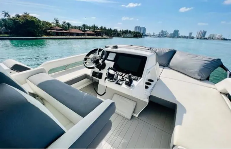 Rio Yacht Photos Pics 2017 Cruisers Yachts 60 Flybridge interior with helm, overlooking scenic waterfront.