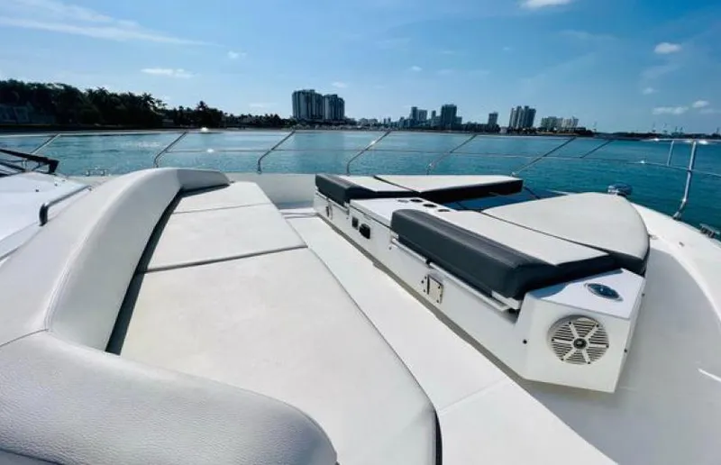 Rio Yacht Photos Pics 2017 Cruisers Yachts 60 Fly deck with sun loungers, overlooking a city skyline.