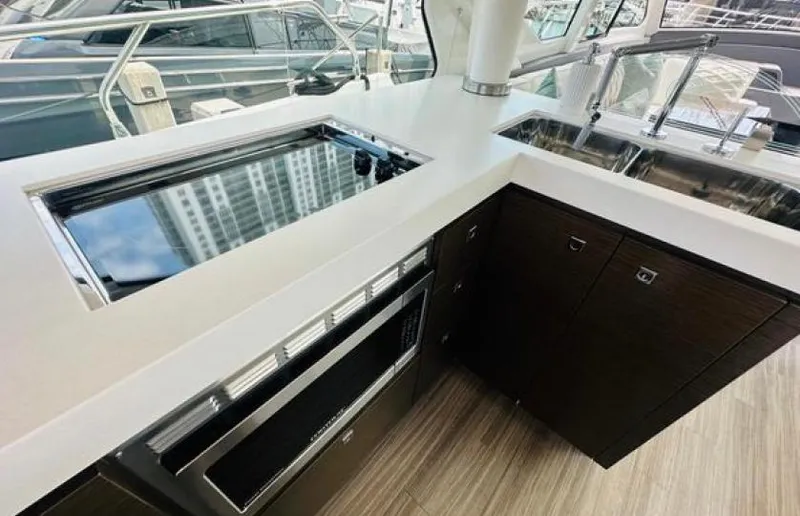 Rio Yacht Photos Pics Modern kitchen area on 2017 Cruisers Yachts 60 Fly, featuring sleek countertops and appliances.