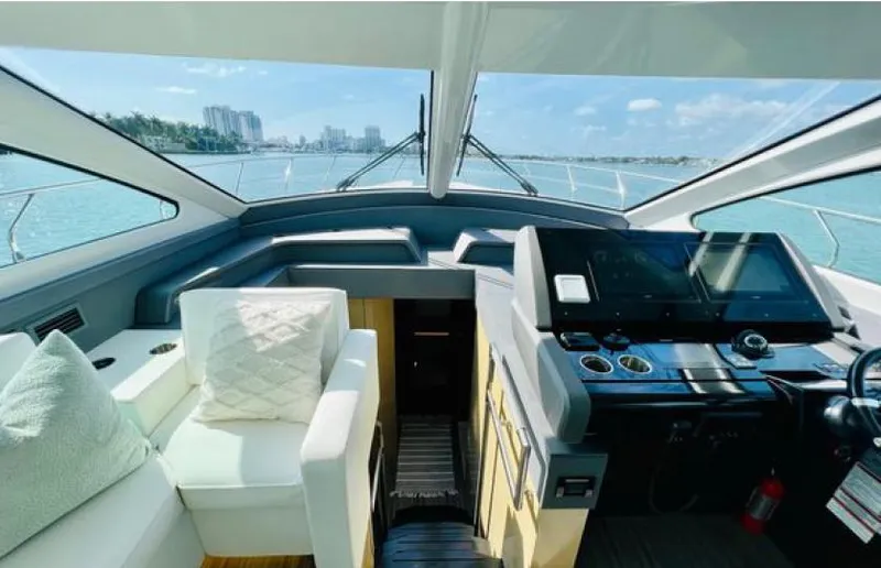 Rio Yacht Photos Pics Interior view of 2017 Cruisers Yachts 60 Fly, featuring helm and seating area.