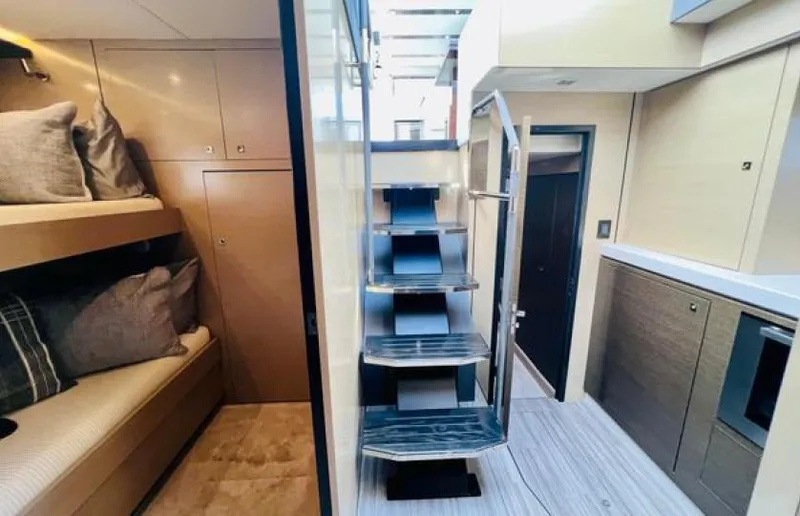 Rio Yacht Photos Pics Luxurious interior of 2017 Cruisers Yachts 60 Fly with modern staircase and cozy bunk beds.