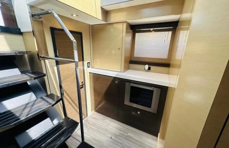 Rio Yacht Photos Pics Modern kitchen interior on 2017 Cruisers Yachts 60 Fly, featuring sleek cabinetry and stainless steel appliances.