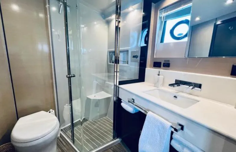 Rio Yacht Photos Pics Luxurious bathroom in 2017 Cruisers Yachts 60 Fly with modern fixtures and glass shower.