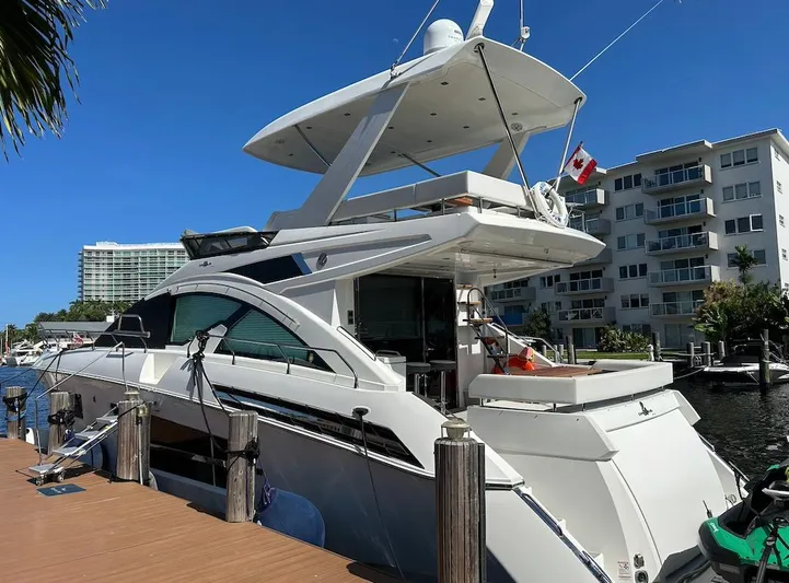 Rio Yacht Photos Pics 2017 Cruisers Yachts 60 Fly docked, featuring sleek design and Canadian flag.