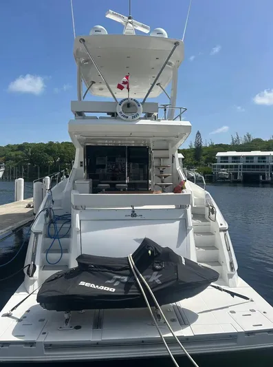 Rio Yacht Photos Pics Luxury 2017 Cruisers Yachts 60 Fly docked, featuring spacious deck and Sea-Doo jet ski.