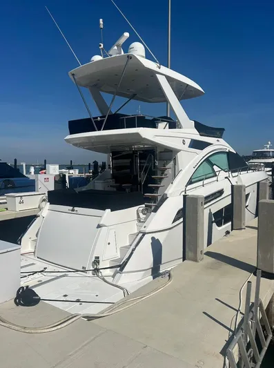 Rio Yacht Photos Pics 2017 Cruisers Yachts 60 Fly docked at marina under clear blue sky.