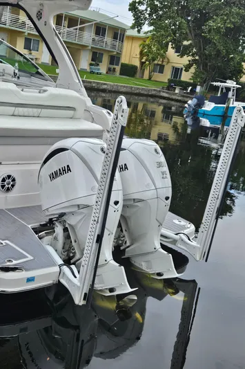  Yacht Photos Pics 2022 Regal 33 XO boat with Yamaha outboard engines docked by waterfront.
