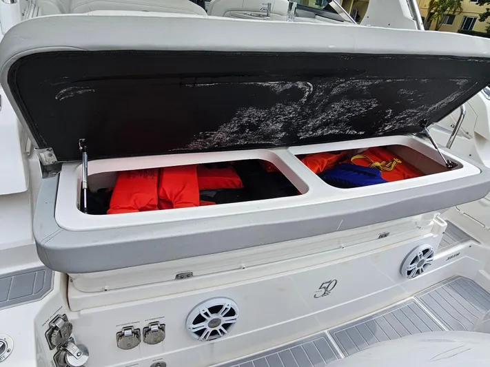 Yacht Photos Pics Open storage compartment on 2022 Regal 33 XO boat with life jackets inside.
