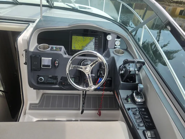  Yacht Photos Pics 2022 Regal 33 XO boat helm with navigation display and controls.
