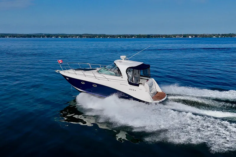 Escape Yacht Photos Pics 2009 Rinker 360 Express Cruiser speeding on open water with Canadian flag.