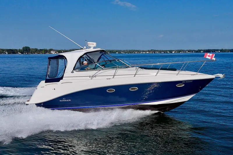 Escape Yacht Photos Pics 2009 Rinker 360 Express Cruiser on water, Canadian flag, clear blue sky.