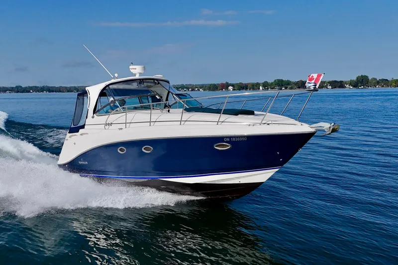 Escape Yacht Photos Pics 2009 Rinker 360 Express Cruiser navigating on a clear blue lake.