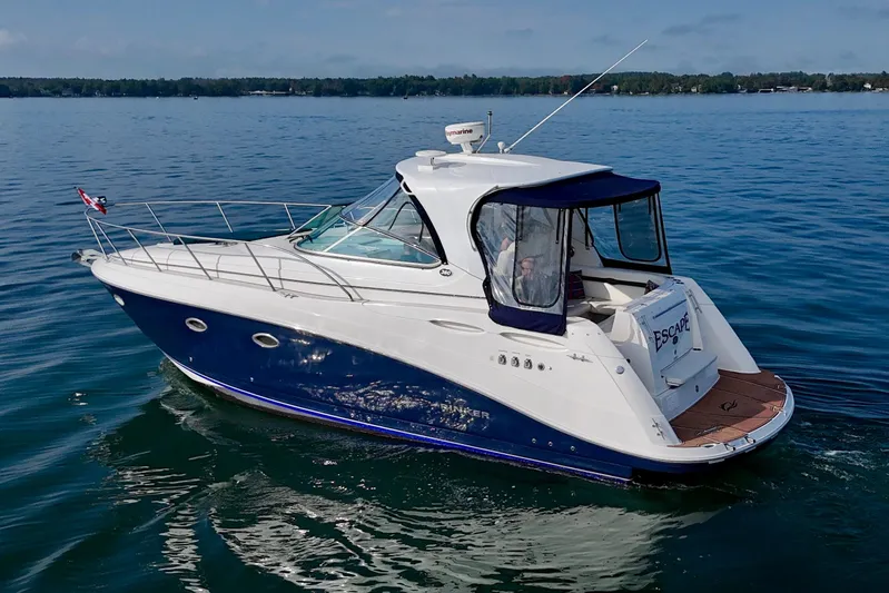 Escape Yacht Photos Pics 2009 Rinker 360 Express Cruiser on calm water, featuring sleek design and spacious deck.