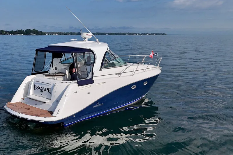 Escape Yacht Photos Pics 2009 Rinker 360 Express Cruiser on calm water, featuring sleek design and Canadian flag.