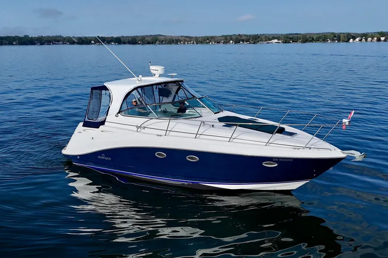 Escape Yacht Photos Pics 2009 Rinker 360 Express Cruiser on calm water, showcasing sleek design and luxury features.