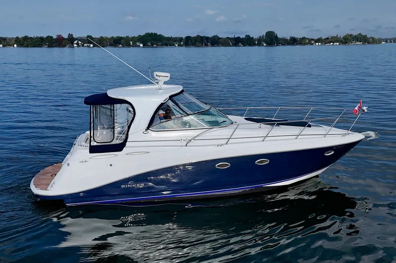 Escape Yacht Photos Pics 2009 Rinker 360 Express Cruiser on calm water, side view.