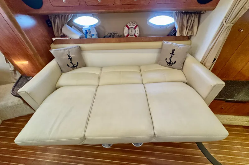 Escape Yacht Photos Pics 2009 Rinker 360 Express Cruiser interior with cream sofa and anchor-themed pillows.