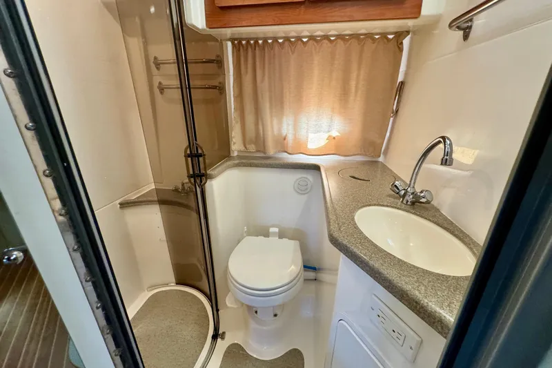 Escape Yacht Photos Pics 2009 Rinker 360 Express Cruiser bathroom with shower, sink, and toilet.