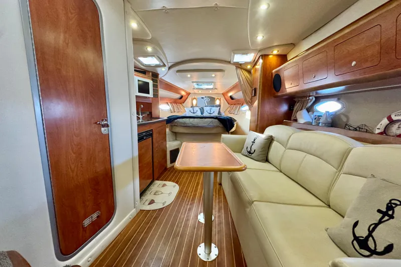 Escape Yacht Photos Pics Interior of 2009 Rinker 360 Express Cruiser with cozy seating and elegant wood finishes.