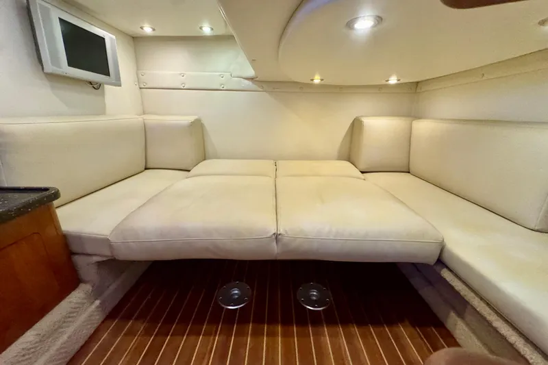 Escape Yacht Photos Pics 2009 Rinker 360 Express Cruiser interior with beige seating and wood flooring.
