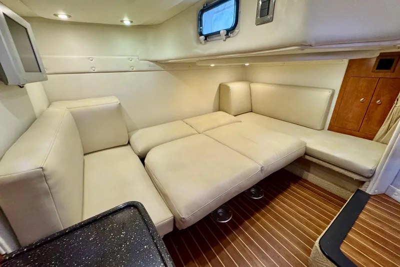 Escape Yacht Photos Pics 2009 Rinker 360 Express Cruiser interior with beige seating and wood flooring.
