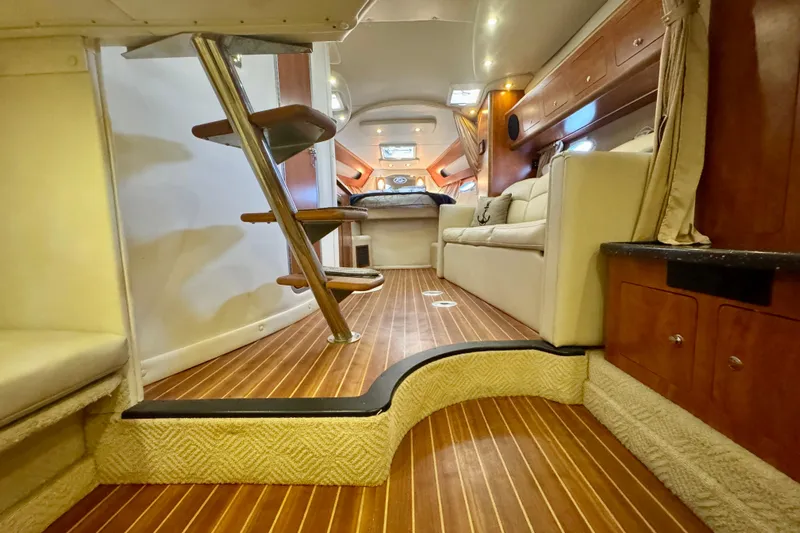 Escape Yacht Photos Pics 2009 Rinker 360 Express Cruiser interior with wooden flooring and cozy seating area.