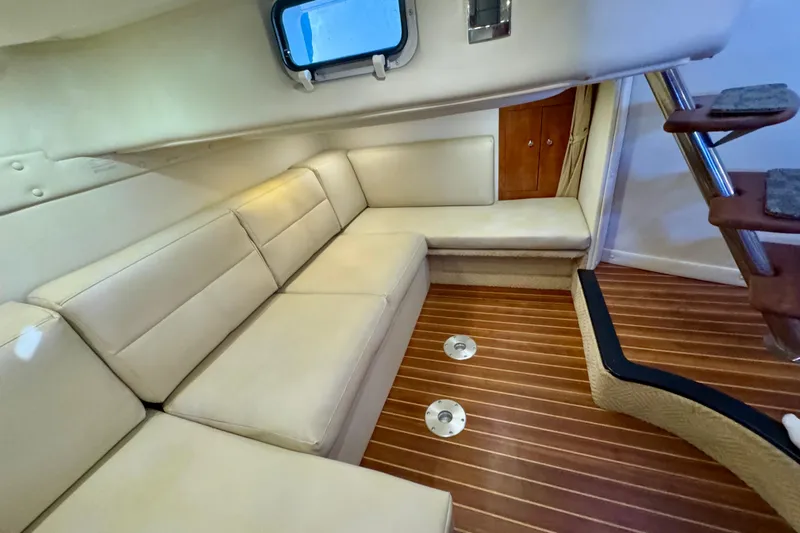 Escape Yacht Photos Pics 2009 Rinker 360 Express Cruiser interior with beige seating and wooden flooring.