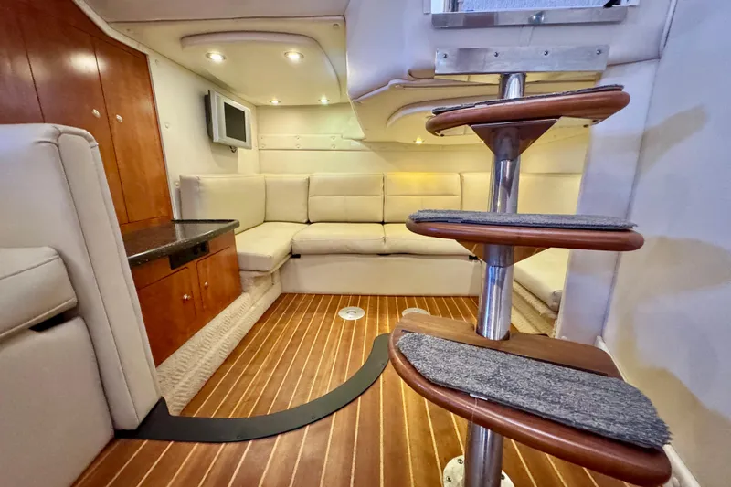 Escape Yacht Photos Pics 2009 Rinker 360 Express Cruiser interior with wooden flooring and cozy seating area.