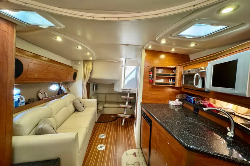 Escape Yacht Photos Pics Interior of 2009 Rinker 360 Express Cruiser with modern kitchen and cozy seating area.